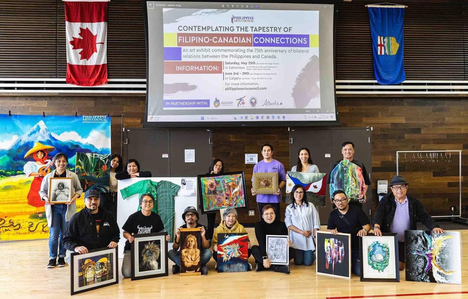 All the Filipino artists who attended gather together showing one artwork each that they brought to the exhibit on May 25. Credit: Philippine Arts Council